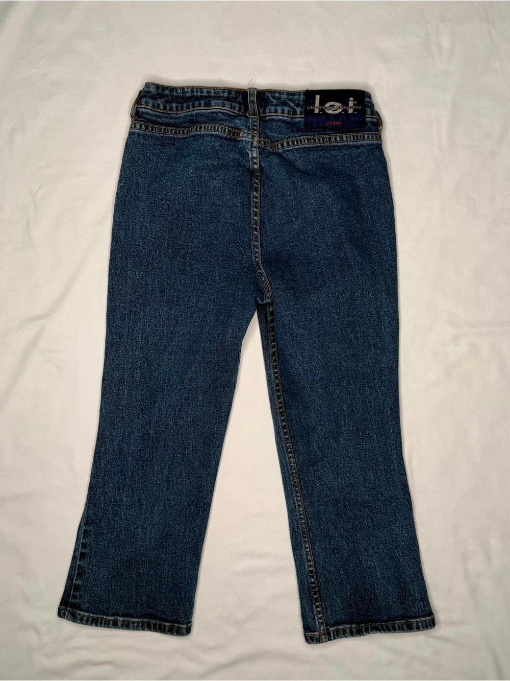 Vintage mid-wash blue denim l.e.i. bootcut jeans for girls.